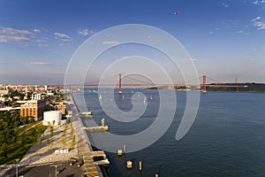 Aerial view of the city of Lisbon with sail boats on the Tagus River Rio Tejo and the 25 of April Bridge on the background;