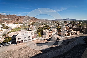 Aerial view of the city with the mountains in the background from the Bahla Fort, Oman