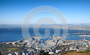 Aerial view of a city and ocean with harbor in Cape Town during the day. Scenic landscape view of a small port, urban