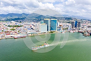 Aerial view of city of Port of Spain, the capital city of Trinidad and Tobago. Skyscrapers of the downtown and a busy sea port photo