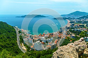 aerial view of the city on the seashore and mountains, panorama of the resorts of Becici and Budva in Montenegro, Adriatic sea,