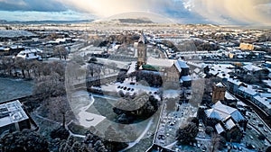 an aerial view of the city with snow covered grounds and buildings