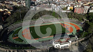 Aerial view City and stadium with playing field and running track Arena Civica. Drone view of spring trees in Sempione