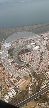 Aerial view of cityscape with buildings near coastline captured from an airplane, Lisbon, Portugal