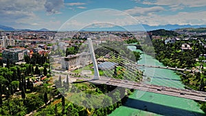 Aerial view of the cityscape of Podgorica behind the Millennium Bridge, a cable-stayed bridge over the Moracha