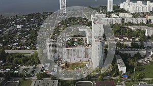 Aerial view of a cityscape and a river far in the distance. Action. Sleeping area, flying over the modern city district