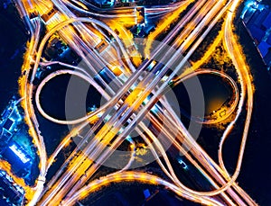 Aerial view of cityscape and traffic on highway at night