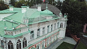 Aerial view of a classic merchant house of IX century. Stock footage. Restored white two storey architectural building