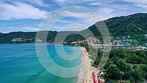 Aerial view of clear sea water with boats and tourists enjoying the beach in Patong beach, Phuket island, Thailand.