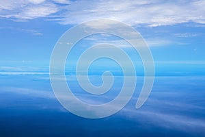 Aerial view with cloud ripples above the ocean and fluffy cloudscape