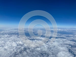 An aerial view of clouds with blue skies