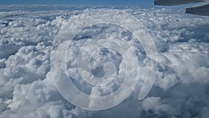 Aerial view of clouds, blue sunny sky, bird's-eye view.