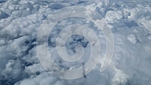 Aerial view of clouds, blue sunny sky, bird's-eye view.