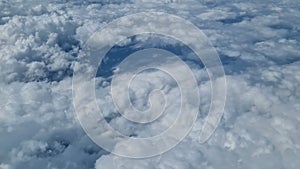 Aerial view of clouds, blue sunny sky, bird's-eye view.