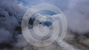 Aerial view of clouds covering mountain range, creating a dramatic landscape. Bezengi