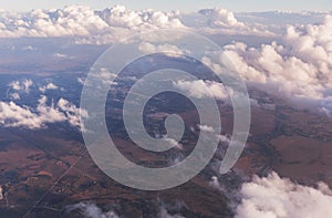 Aerial view of clouds lit by the evening sun over Florida, view from the aircraft during the flight.