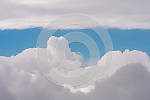 Aerial view of clouds outside of an airplane window