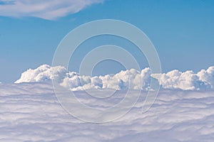 Aerial view of clouds outside of an airplane window