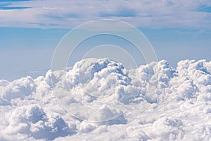 Aerial view of clouds outside of an airplane window