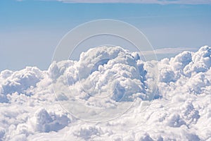 Aerial view of clouds outside of an airplane window
