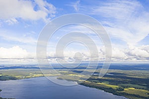 Aerial view clouds over the forest and lake. View from drone. Aerial top view cloudscape. Texture of clouds. View from above. Sunr