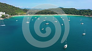 Aerial view through clouds of Phuket Island, Nai Han Beach with ships, Thailand