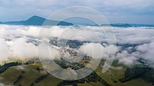 Aerial view through clouds to the city of Dolny Kubin