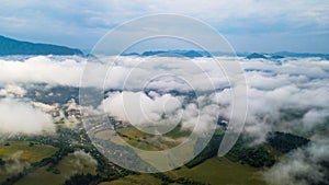 Aerial view through clouds to the city of Dolny Kubin