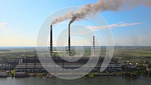 Aerial view of coal power plant high pipes with black smokestack polluting atmosphere. Electricity production with