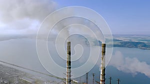 Aerial view of coal power plant high pipes with black smokestack polluting atmosphere. Electricity production