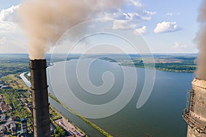 Aerial view of coal power plant high pipes with black smokestack polluting atmosphere. Electricity production with
