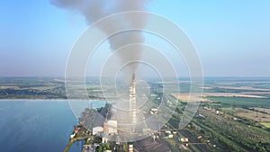 Aerial view of coal power plant high pipes with black smokestack polluting atmosphere. Electricity production