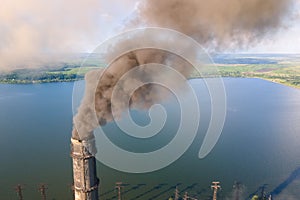 Aerial view of coal power plant high pipes with black smokestack polluting atmosphere. Electricity production with