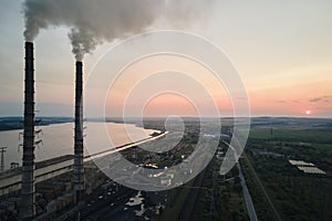 Aerial view of coal power plant high pipes with black smokestack polluting atmosphere. Electricity production with