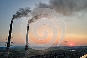 Aerial view of coal power plant high pipes with black smokestack polluting atmosphere. Electricity production with