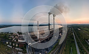 Aerial view of coal power plant high pipes with black smokestack polluting atmosphere. Electricity production with