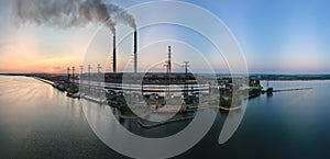 Aerial view of coal power plant high pipes with black smokestack polluting atmosphere. Electricity production with