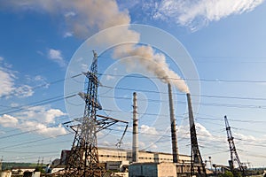 Aerial view of coal power plant high pipes with black smokestack polluting atmosphere. Electricity production with fossil fuel