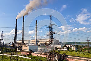 Aerial view of coal power plant high pipes with black smokestack polluting atmosphere. Electricity production with fossil fuel