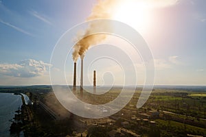 Aerial view of coal power plant high pipes with black smokestack polluting atmosphere. Electricity production with fossil fuel