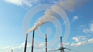 Aerial view of coal power plant high pipes with black smokestack polluting atmosphere. Electricity production with fossil fuel con