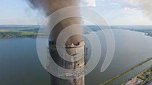 Aerial view of coal power plant high pipes with black smokestack polluting atmosphere. Electricity production with fossil fuel con