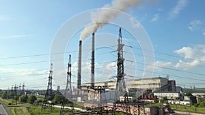 Aerial view of coal power plant high pipes with black smokestack polluting atmosphere. Electricity production with fossil fuel con