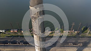 Aerial view of coal power plant high pipes with black smokestack polluting atmosphere. Electricity production with fossil fuel con