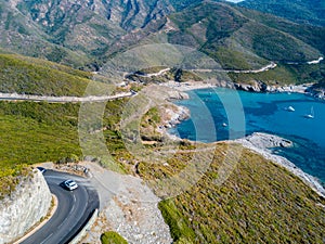Aerial view of the coast of Corsica, winding roads and cove. Gulf of Aliso. France