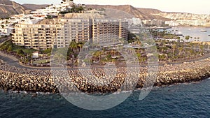 aerial view of the coast of Gran Canaria, resorts, hotels and holiday houses on the beach. Arguineguin