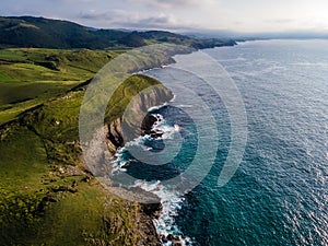 Aerial view of the coast with large cliffs at sunset. Cantabria,