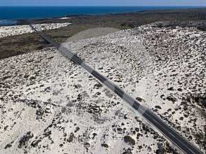 Aerial view of the coastal road that crosses the beaches and coves of MojÃÂ³n Blanco and Spiral Caleta. Lanzarote, Canary Islands,