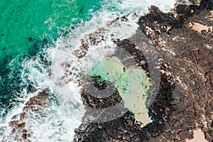 Aerial view of coastal rock pool and ocean