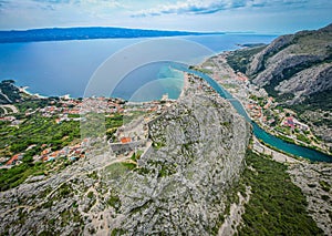 Aerial view of the coastline with vibrant houses and buildings on the rocky hills overlooking ocean